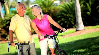 active senior couple enjoying cycling